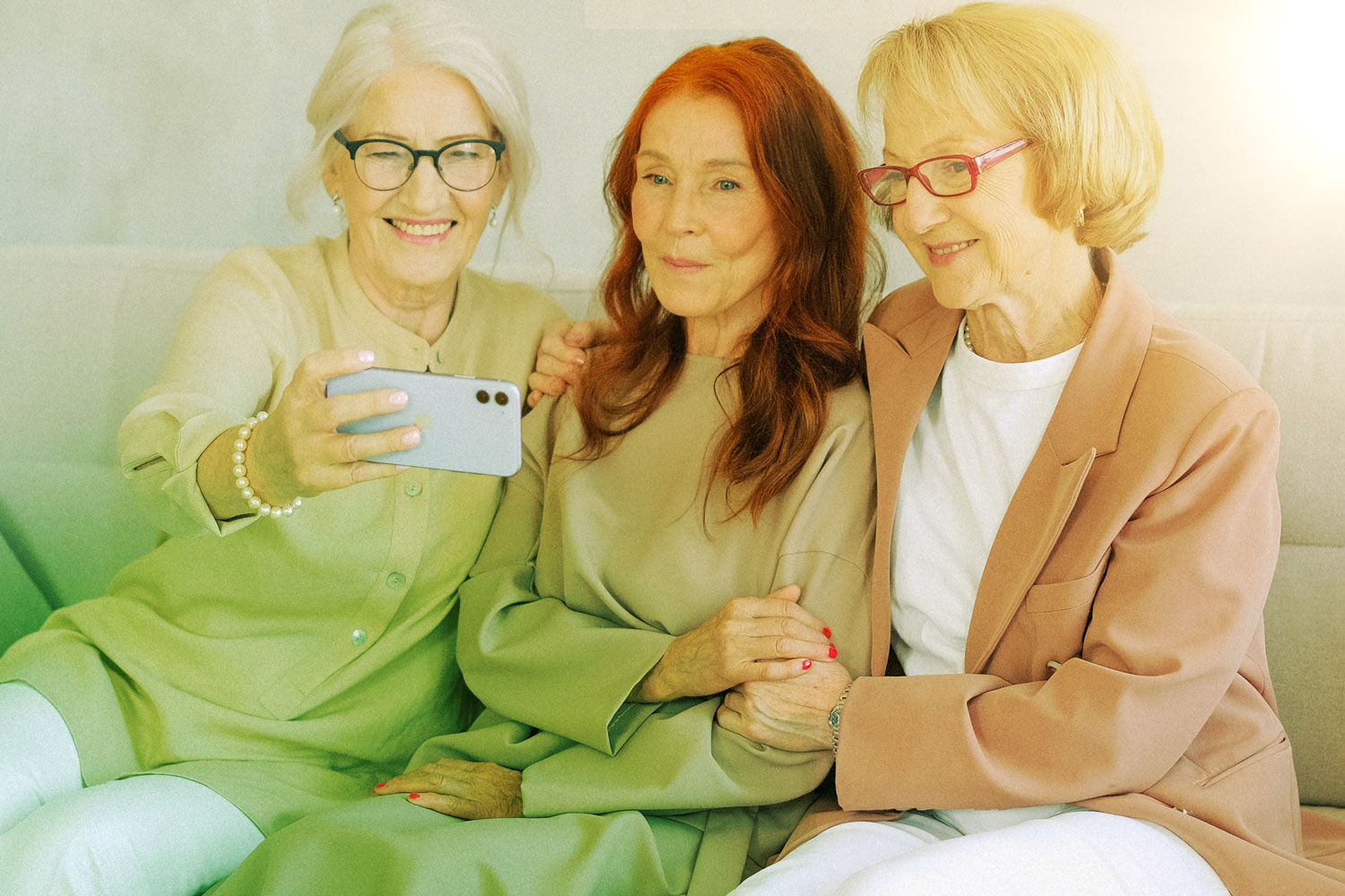 Three women smile for camera